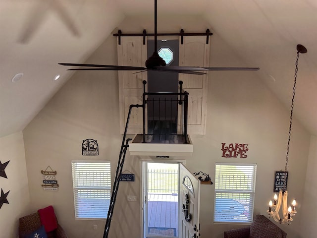 interior space featuring high vaulted ceiling, plenty of natural light, and a notable chandelier