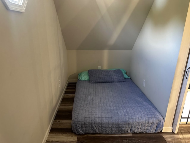 bedroom with lofted ceiling and hardwood / wood-style flooring