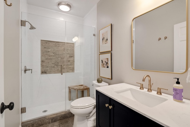 bathroom with vanity, a shower stall, and toilet