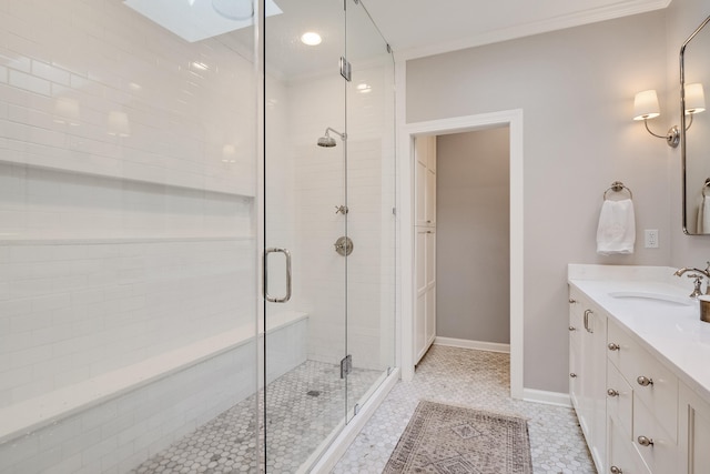 full bathroom featuring ornamental molding, baseboards, a shower stall, and vanity