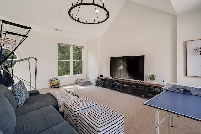 living area featuring carpet floors, an inviting chandelier, visible vents, and high vaulted ceiling