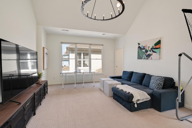 carpeted living area featuring baseboards, a high ceiling, visible vents, and an inviting chandelier