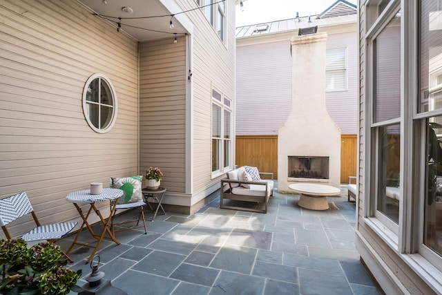 view of patio / terrace featuring an outdoor fireplace