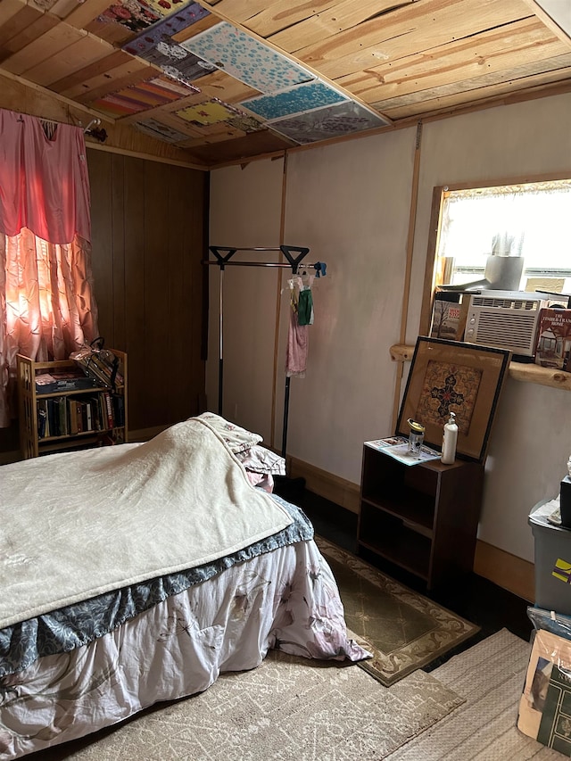 carpeted bedroom with cooling unit, wood walls, and wooden ceiling