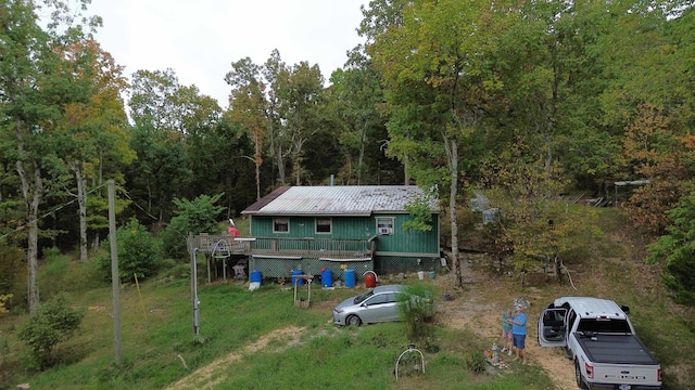 rear view of property featuring a deck