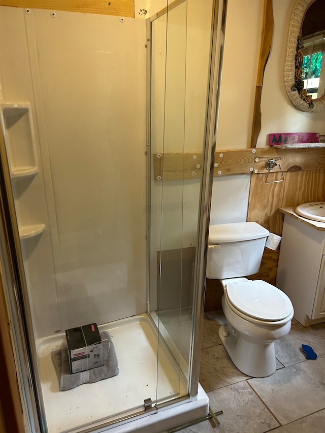 bathroom featuring an enclosed shower, toilet, and vanity