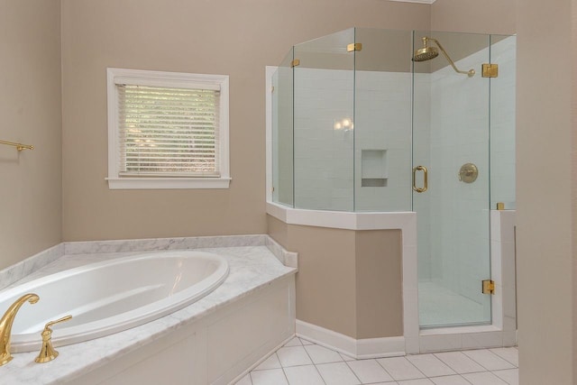 full bath with tile patterned floors, a stall shower, and a garden tub