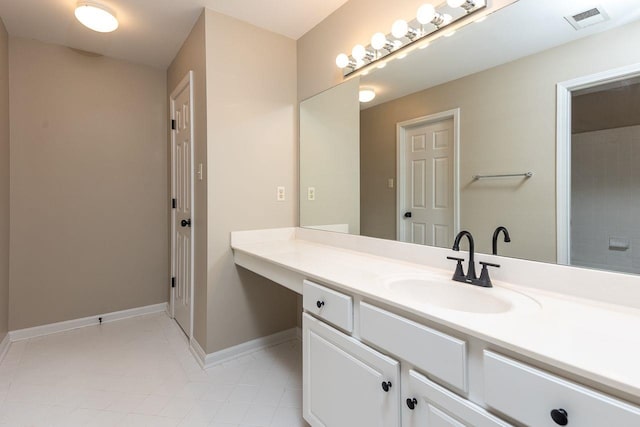 bathroom featuring tile patterned floors, visible vents, baseboards, and vanity