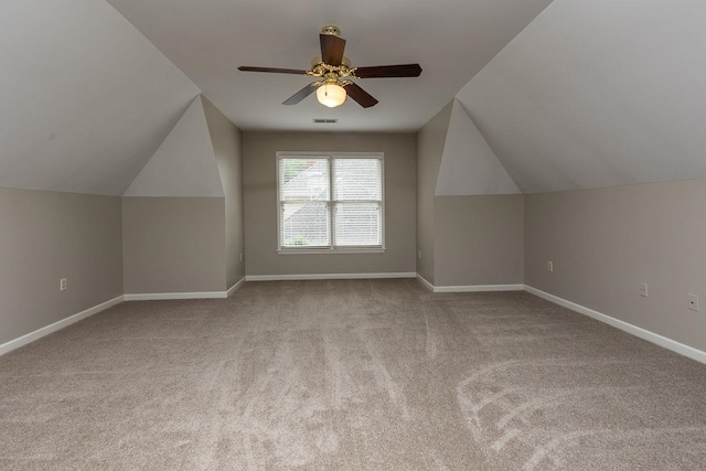 additional living space with visible vents, carpet flooring, baseboards, and ceiling fan