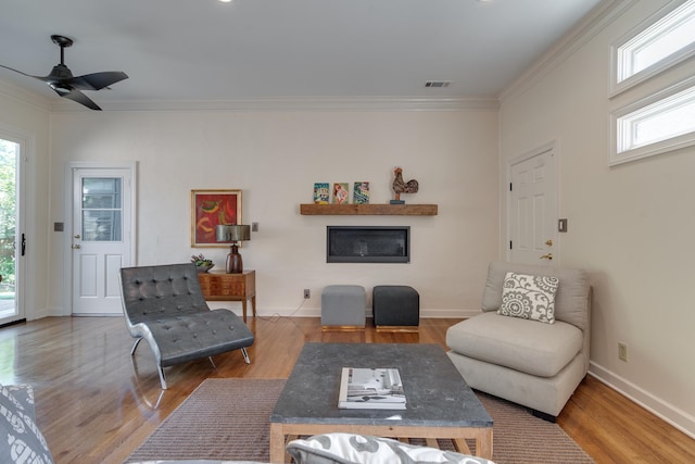 living room with hardwood / wood-style flooring, a wealth of natural light, and ceiling fan