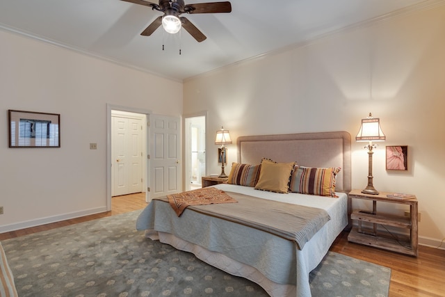 bedroom with light wood-type flooring, crown molding, and ceiling fan