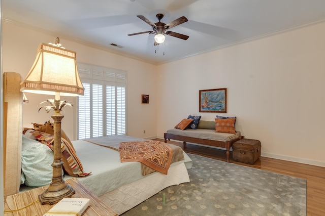 bedroom featuring crown molding, ceiling fan, and wood-type flooring