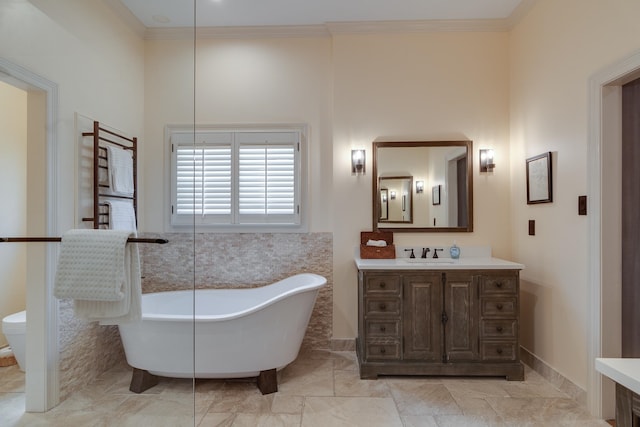 bathroom featuring a washtub, crown molding, and vanity