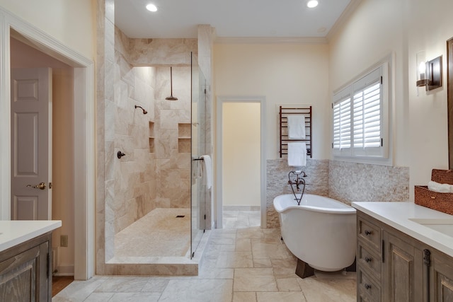 bathroom featuring shower with separate bathtub, crown molding, and vanity