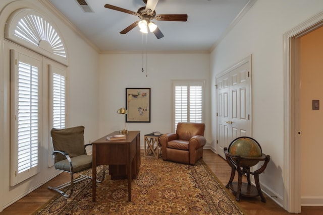 office area featuring crown molding, a healthy amount of sunlight, ceiling fan, and dark hardwood / wood-style flooring