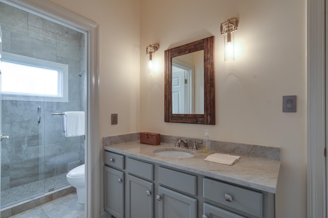 bathroom with a shower with shower door, toilet, and vanity