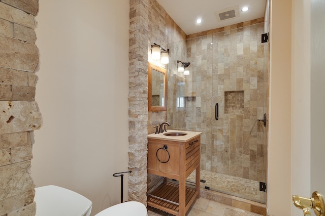 bathroom with vanity, toilet, and walk in shower