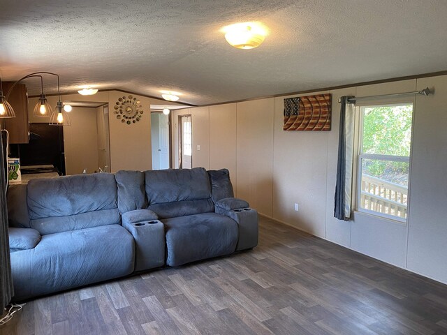 7080 Beauty Hill Rd, Adamsville, TN 38310 - living area with lofted ceiling, a textured ceiling, and wood finished floors