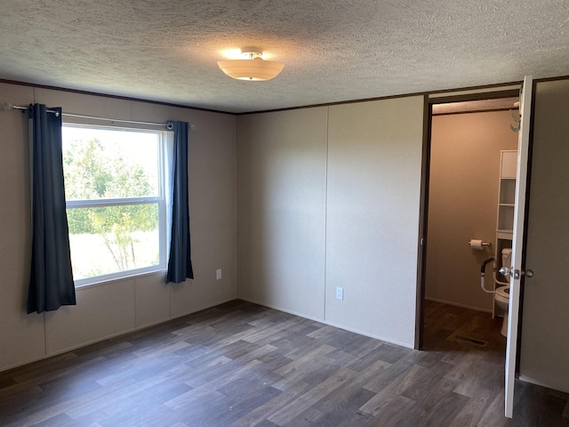 7080 Beauty Hill Rd, Adamsville, TN 38310 - empty room with a textured ceiling and wood finished floors