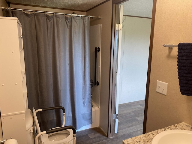 7080 Beauty Hill Rd, Adamsville, TN 38310 - full bathroom featuring toilet, a textured ceiling, shower / bath combo with shower curtain, vanity, and wood finished floors