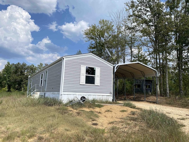 7080 Beauty Hill Rd, Adamsville, TN 38310 - view of side of home with a carport and dirt driveway