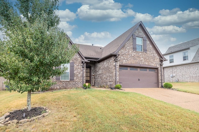 view of front of property with a garage and a front yard