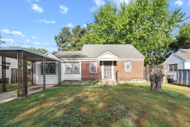 view of front of property featuring a front lawn and a carport