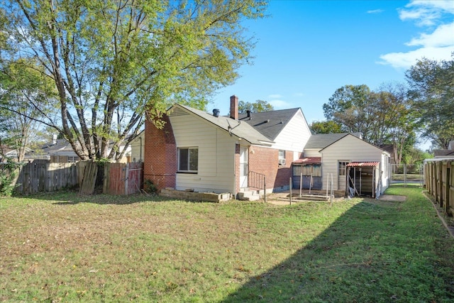 back of property featuring a yard