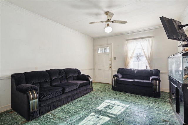 living room with ornamental molding and ceiling fan