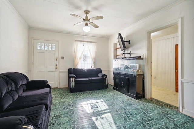 living room featuring ornamental molding and ceiling fan