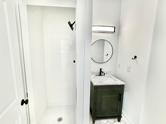 bathroom featuring vanity and tiled shower