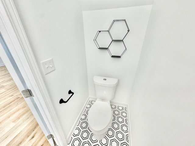 bathroom featuring wood-type flooring and toilet