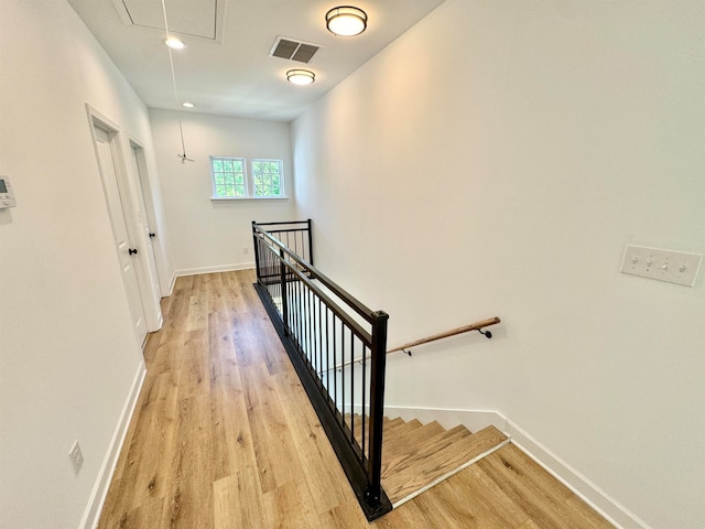 stairs featuring hardwood / wood-style flooring