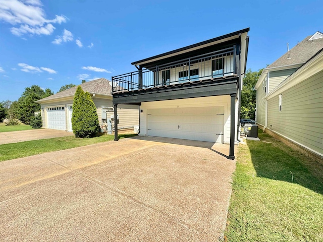 view of front of property with a balcony, a garage, and a front lawn