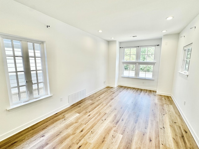 spare room featuring light wood-type flooring