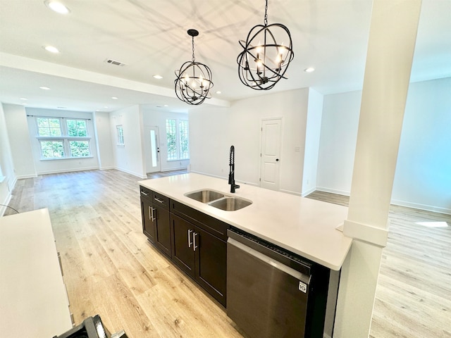 kitchen with decorative light fixtures, dishwasher, plenty of natural light, and a notable chandelier