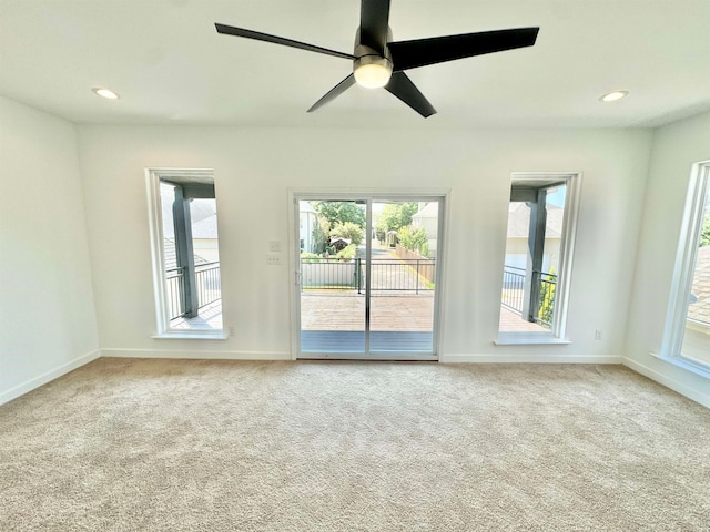 empty room with ceiling fan and carpet