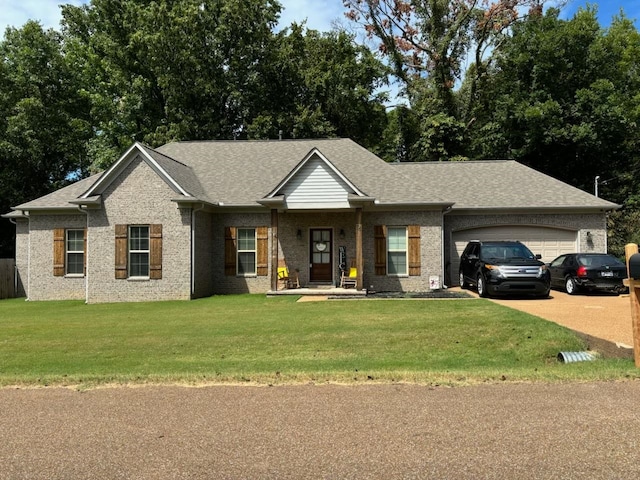 ranch-style home with a garage and a front yard