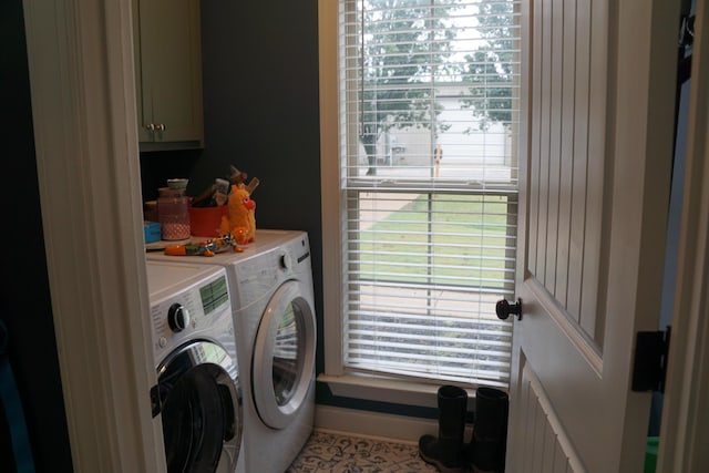 laundry room featuring cabinets and washing machine and clothes dryer