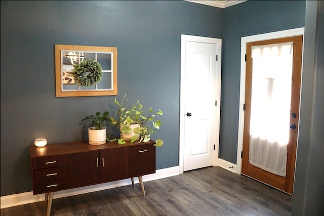 foyer with dark hardwood / wood-style flooring and crown molding