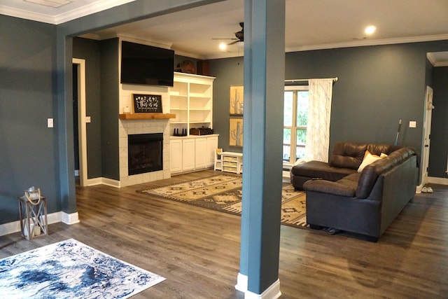 living room with dark wood-type flooring, ceiling fan, and ornamental molding