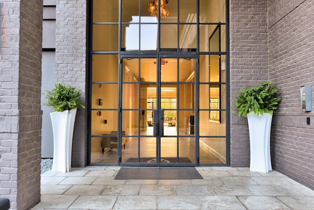 doorway to property with french doors and brick siding