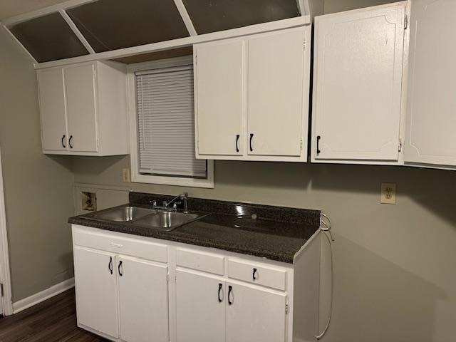 kitchen featuring sink, white cabinets, and dark hardwood / wood-style floors