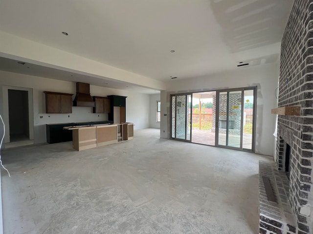 unfurnished living room with a brick fireplace