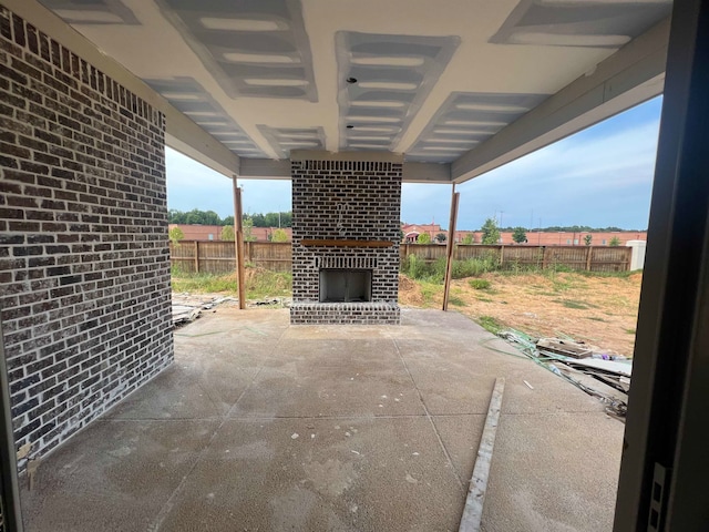 view of patio featuring an outdoor brick fireplace