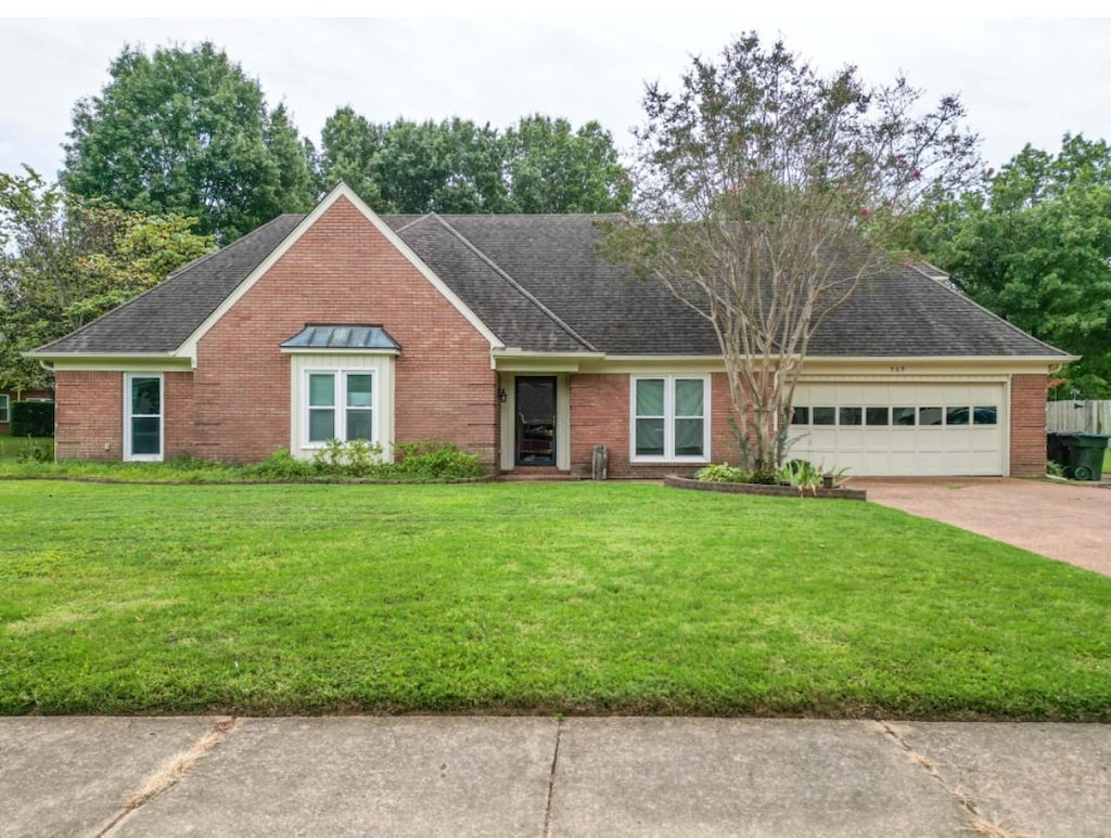 single story home with a garage and a front yard