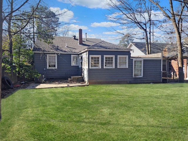 back of property featuring a lawn