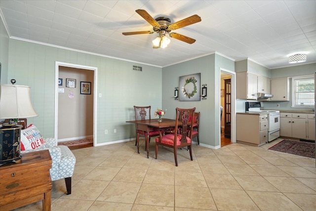 dining room featuring ceiling fan, light tile patterned floors, and crown molding