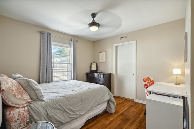 bedroom with ceiling fan and dark hardwood / wood-style floors