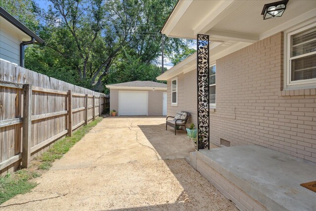 exterior space with an outdoor structure, a garage, and a patio area